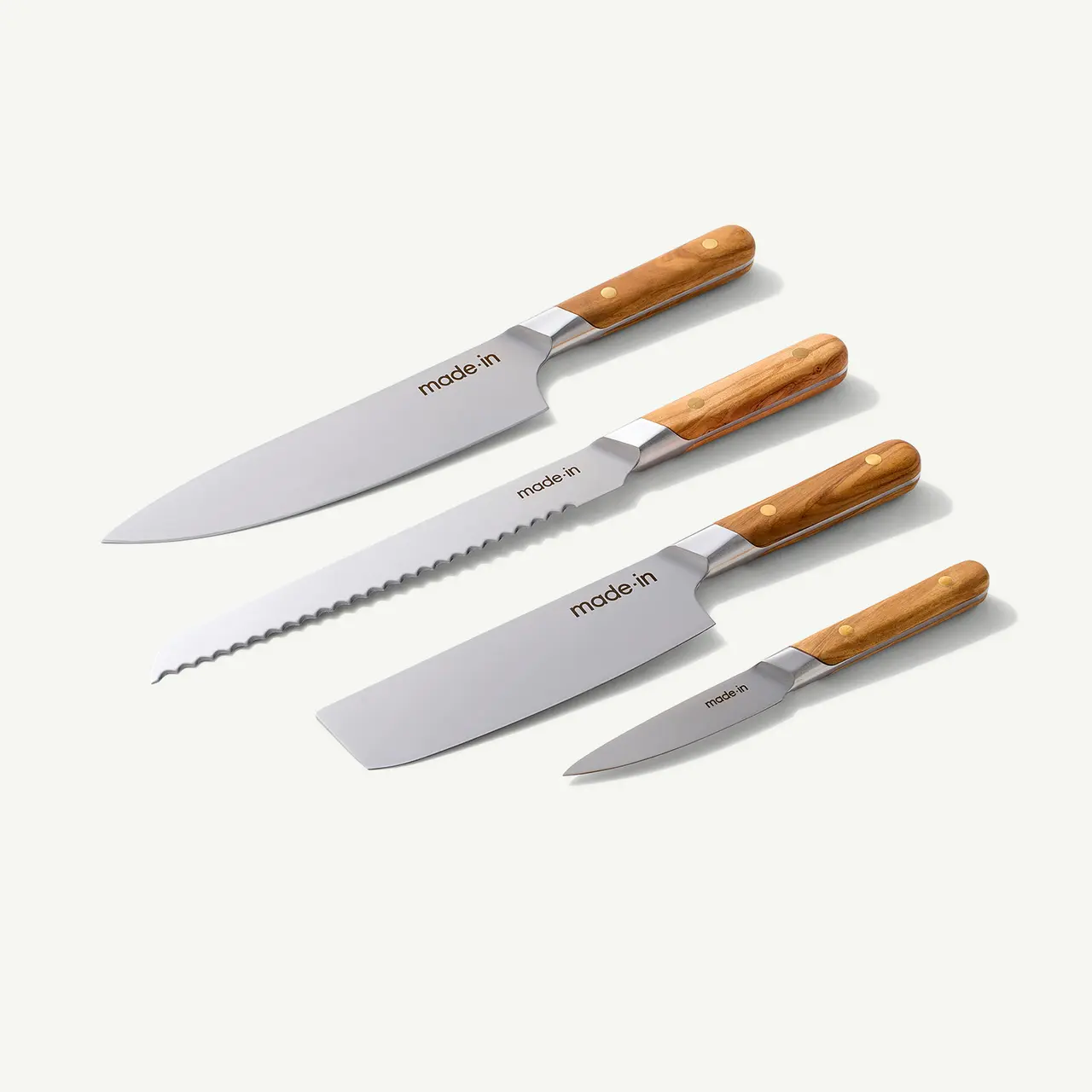 Four different types of kitchen knives with wooden handles are displayed on a light background.