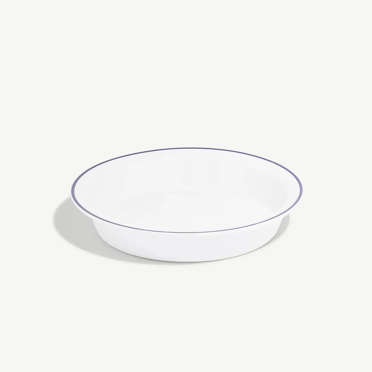 A simple white bowl with a blue rim on a plain background.