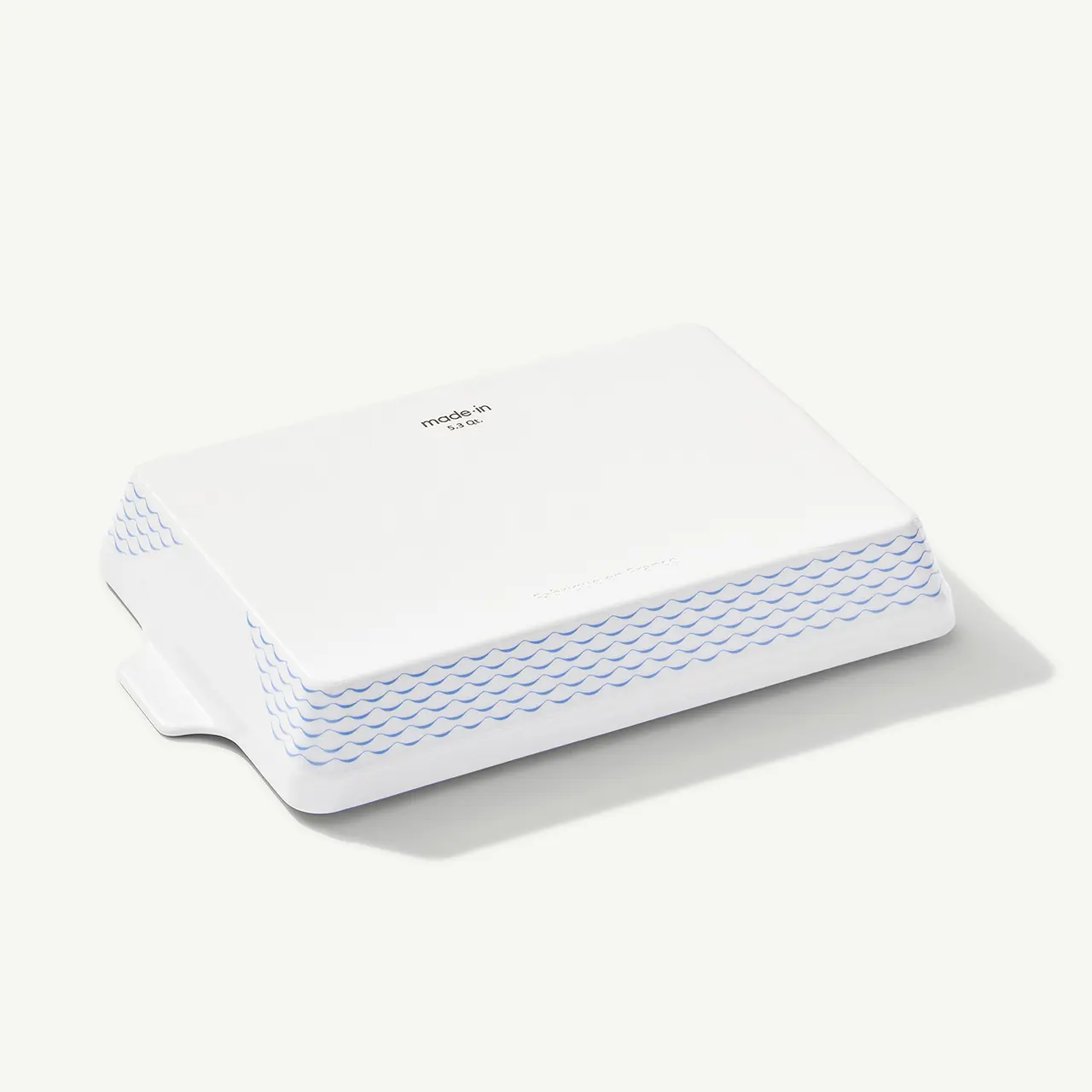 A white wireless router with a textured design on the front edge is displayed on a plain background.