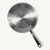 A stainless steel frying pan with a black handle is depicted against a light background.
