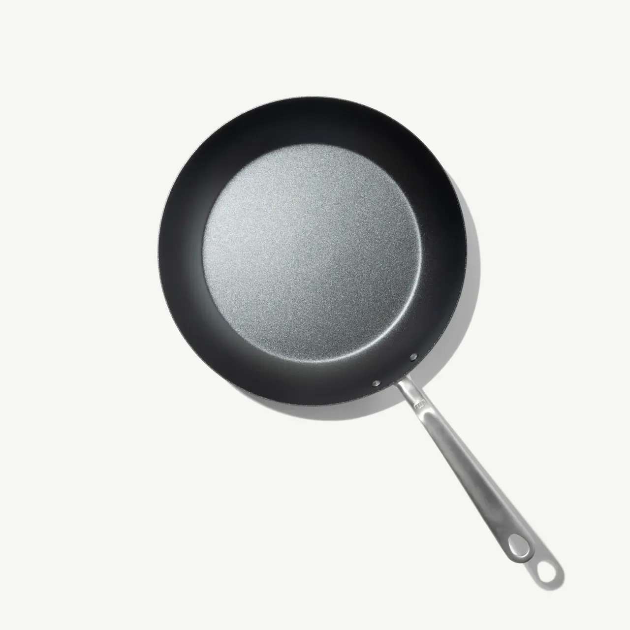 A sleek, circular frying pan with a non-stick surface and a stainless steel handle is presented against a light background.