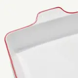 A white square serving tray with a red rim and the word "modern" embossed on one side.