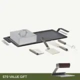 A complete grilling set featuring a griddle, a grilling press, and three utensils with sleek handles.