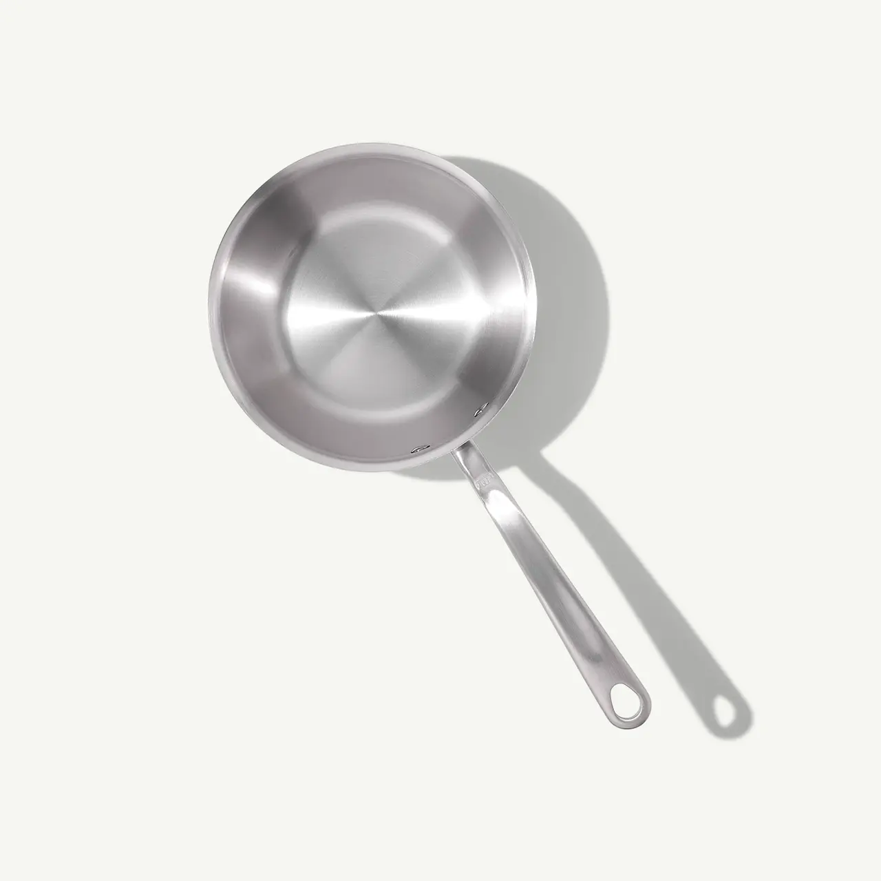 A stainless steel frying pan with a long handle is depicted against a light background.