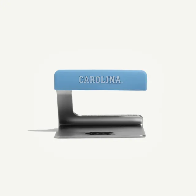 A blue-handled metal scraper with the word "CAROLINA" written on the handle.
