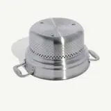 A stainless steel food steamer insert with perforated top and side handles rests on a light background.