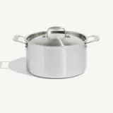 A stainless steel cooking pot with two handles and a lid, isolated on a white background.