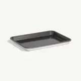 A simple metal baking tray is displayed against a light background.