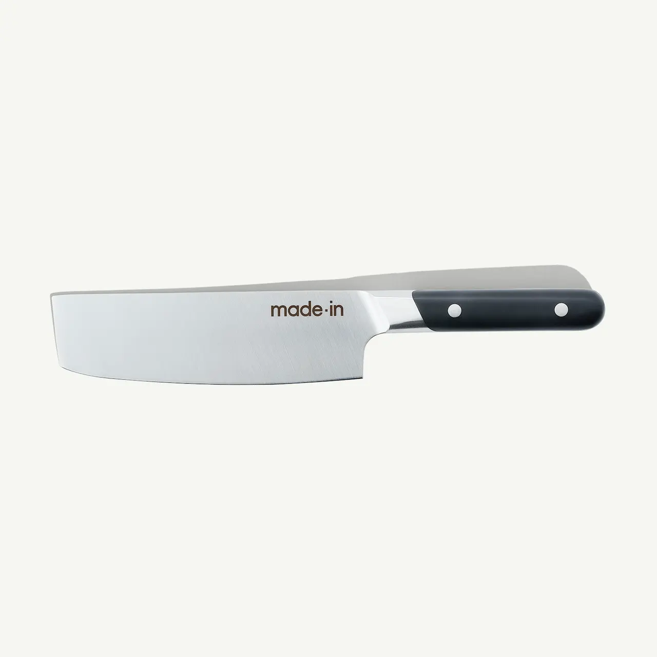 A stainless steel chef's knife with a black handle and the text "made.in" printed on the blade is displayed against a white background.
