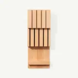 A vertical wooden block puzzle with rectangular pieces partially slid out against a white background.