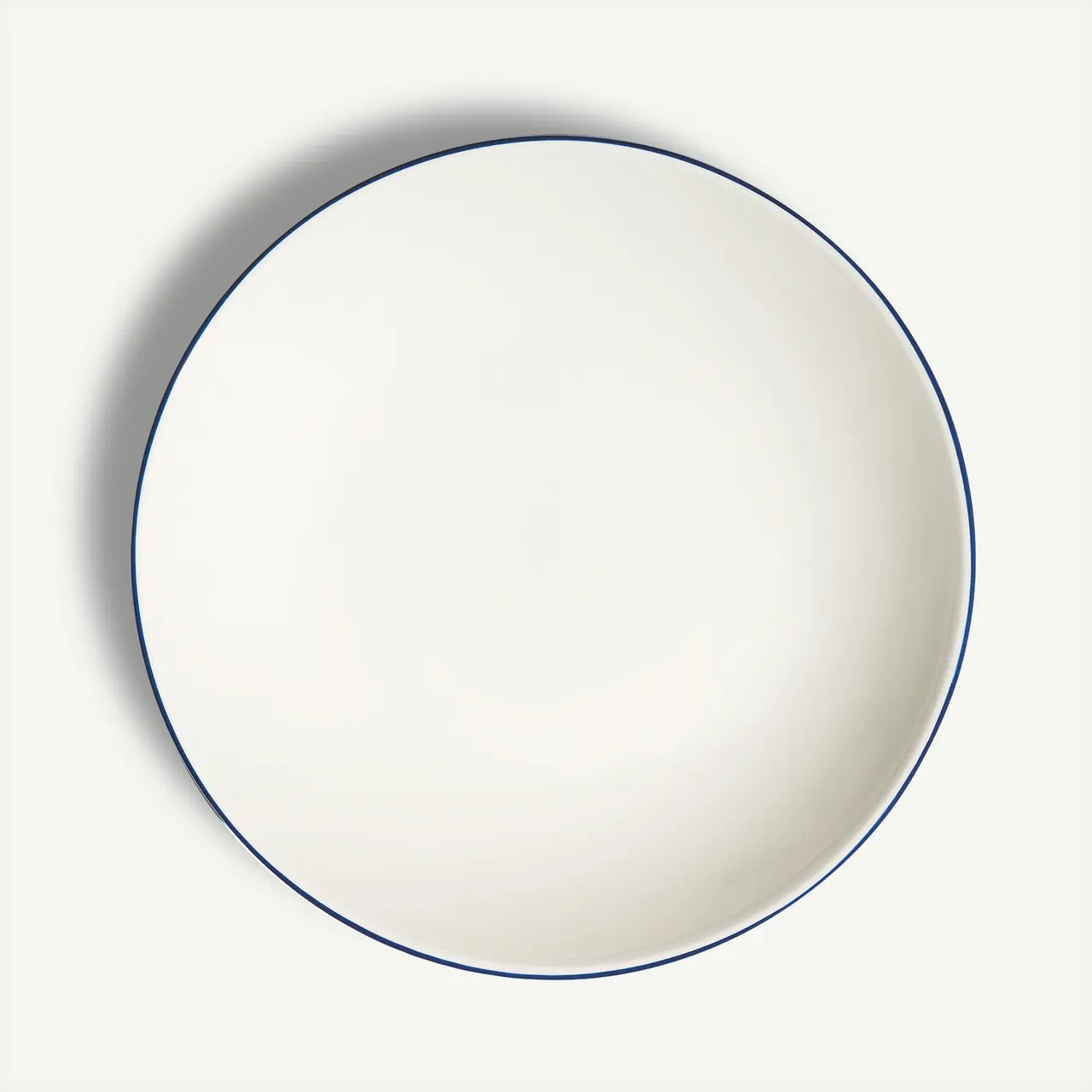 A plain white plate with a simple blue border is displayed against a light background.