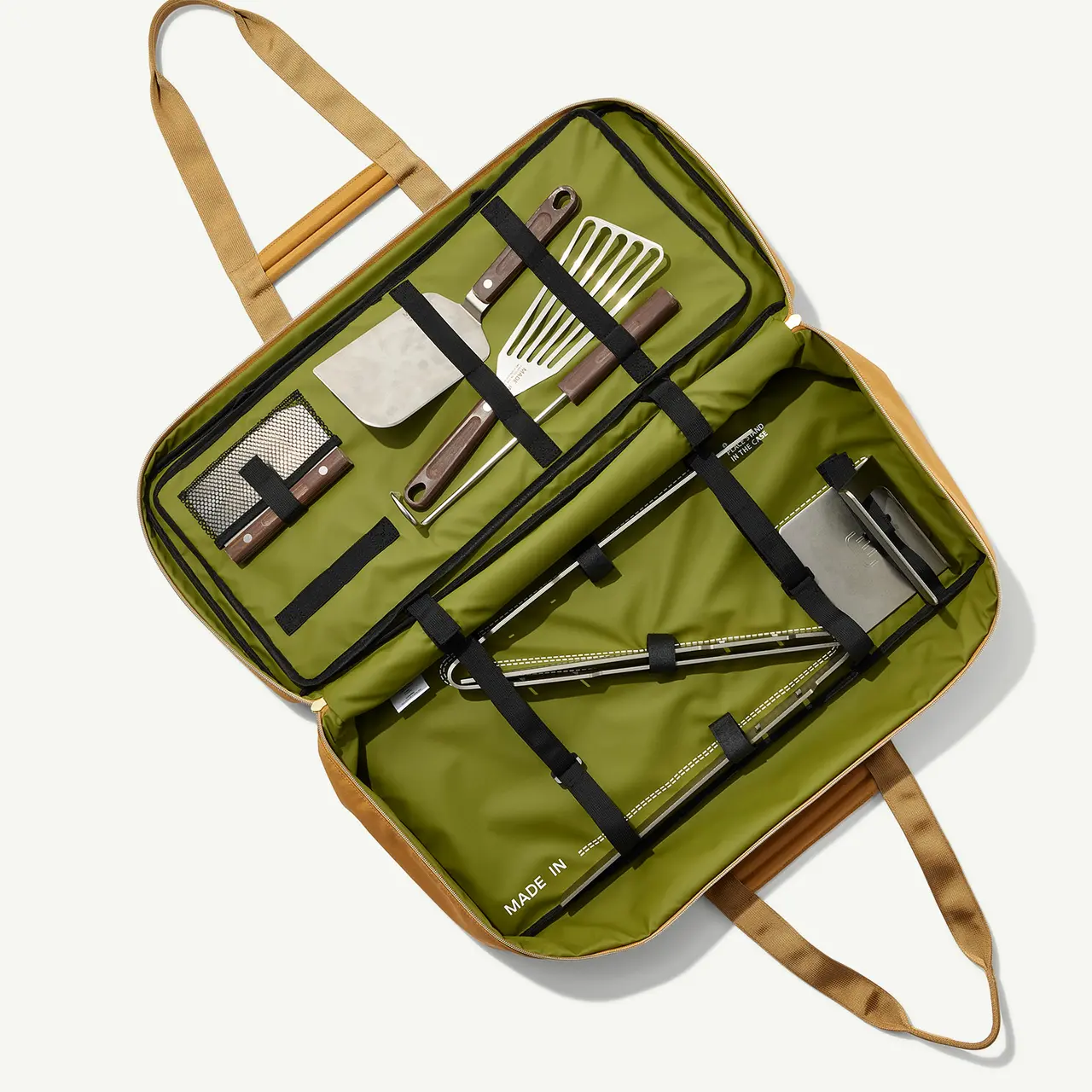 A portable barbecue tool set is neatly organized in a foldable olive-green case.