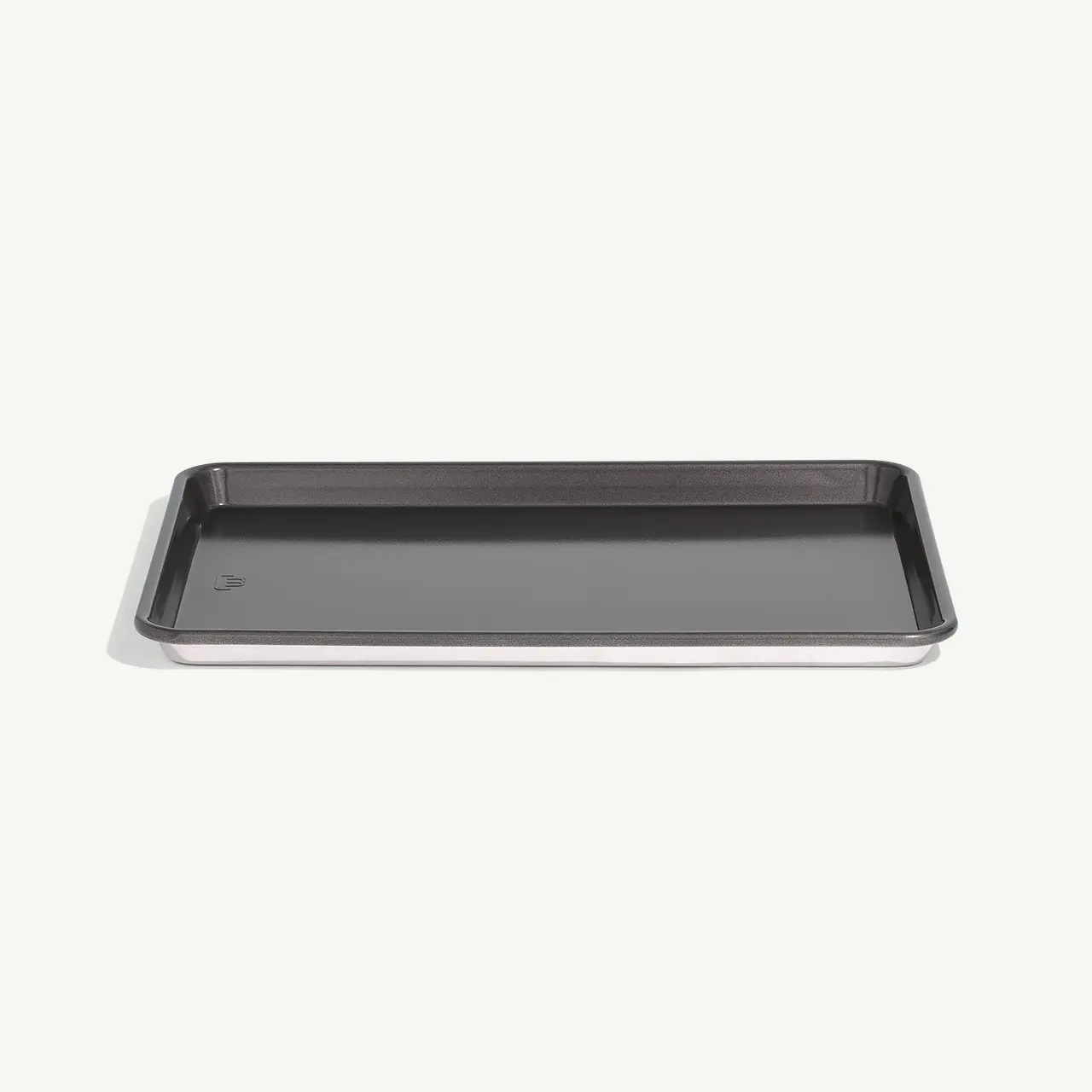 A rectangular, shallow, metal baking tray on a plain background.