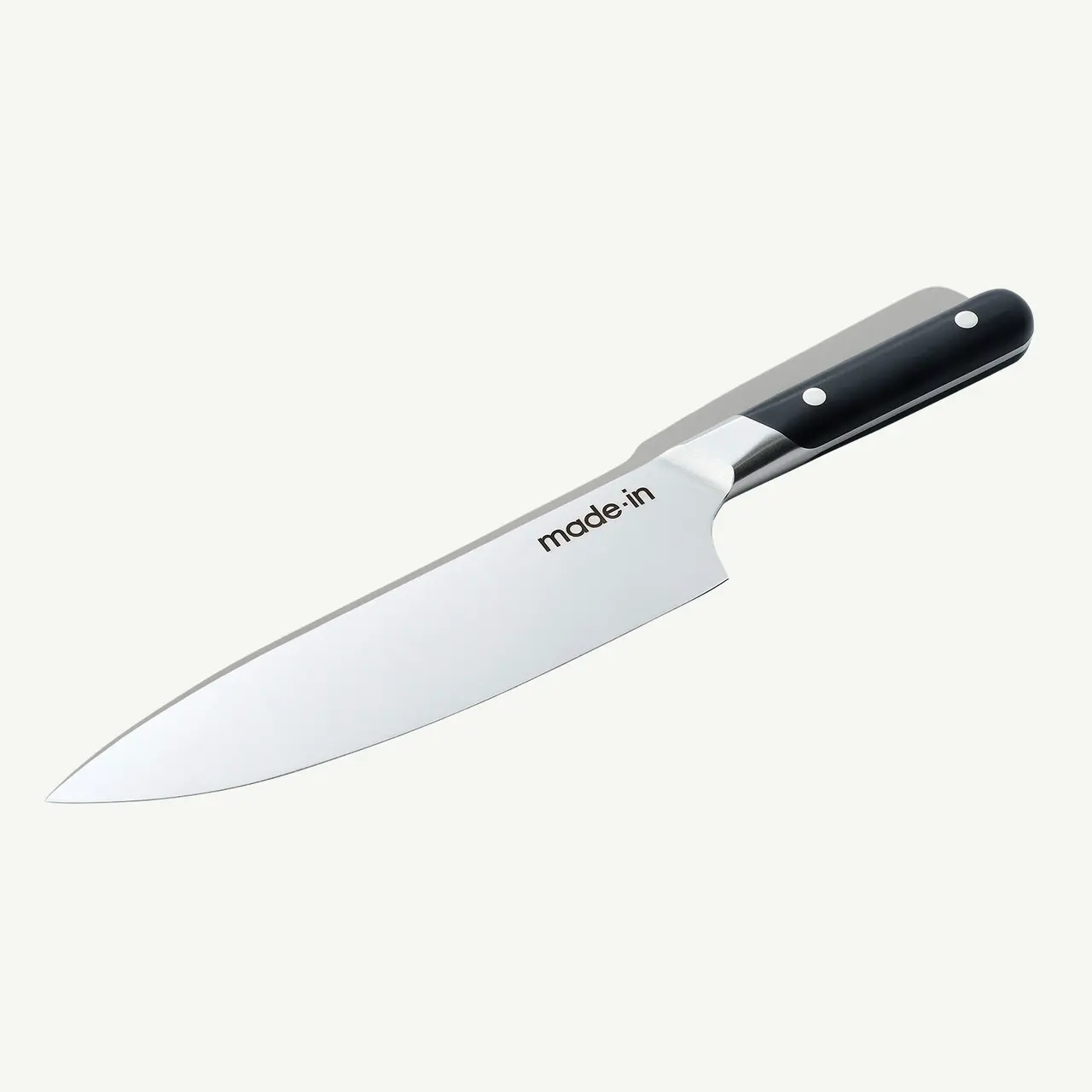 A chef's knife with a black handle and "made in" text on the blade is displayed against a white background.