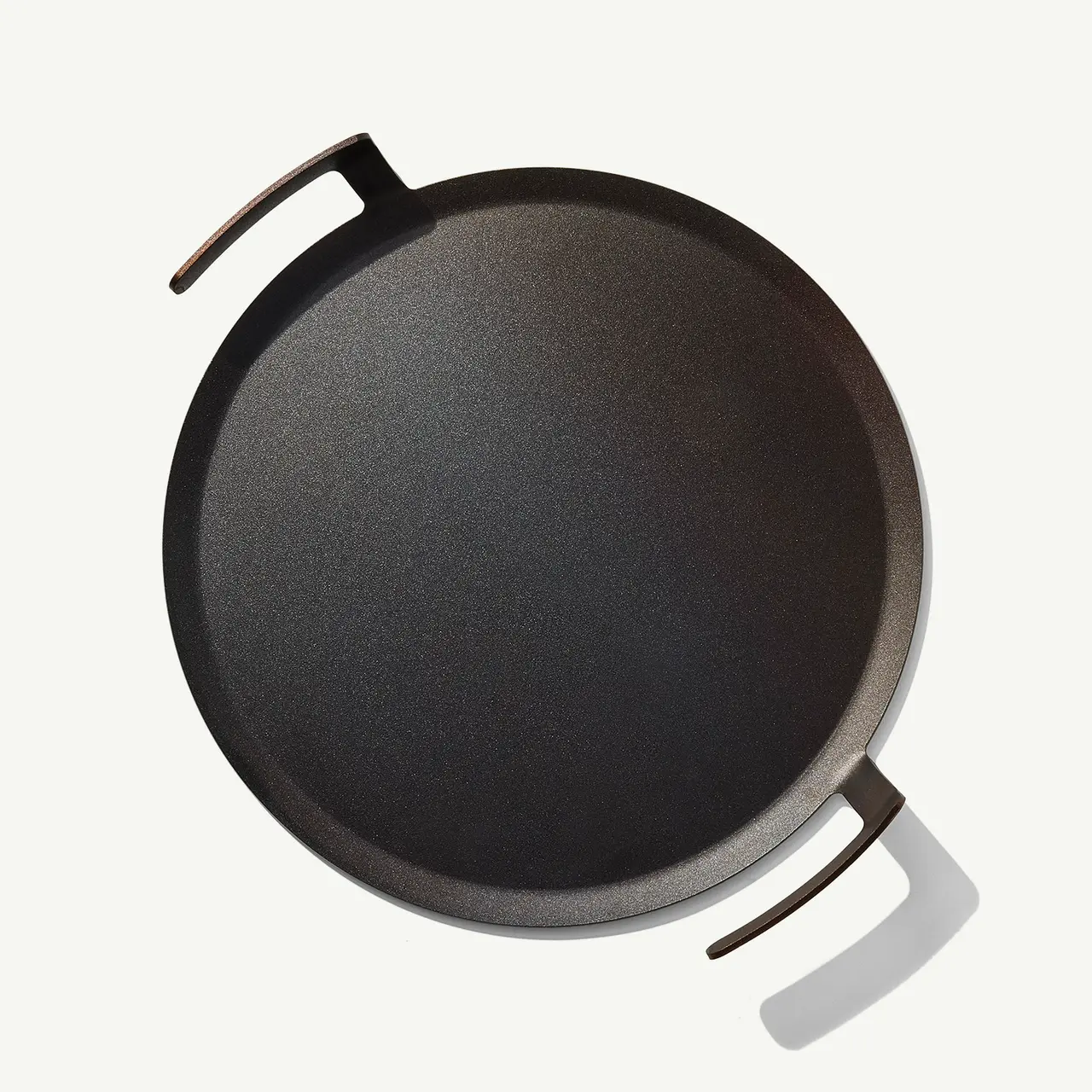 A black non-stick frying pan with two handles is displayed against a white background.