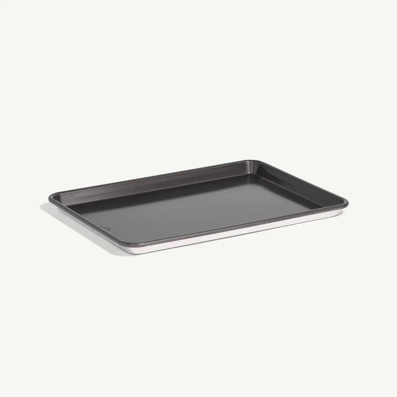 A plain, rectangular, black baking tray on a light background.