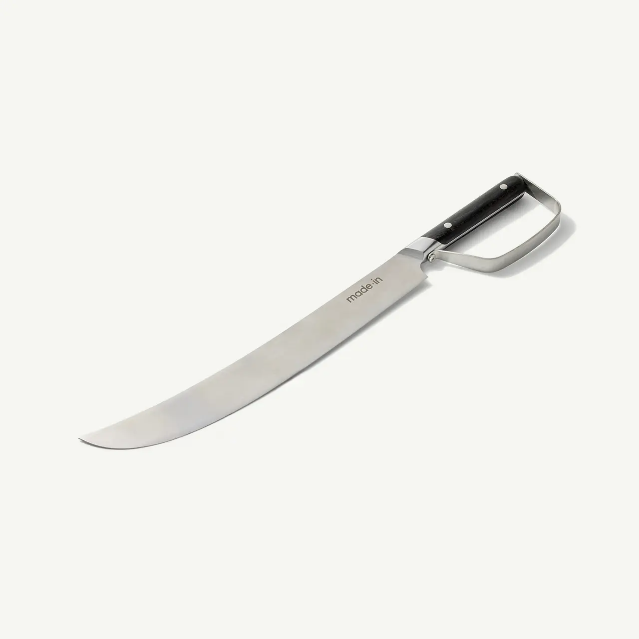 A stainless steel kitchen knife with a curved blade and a black handle lies on a white surface.