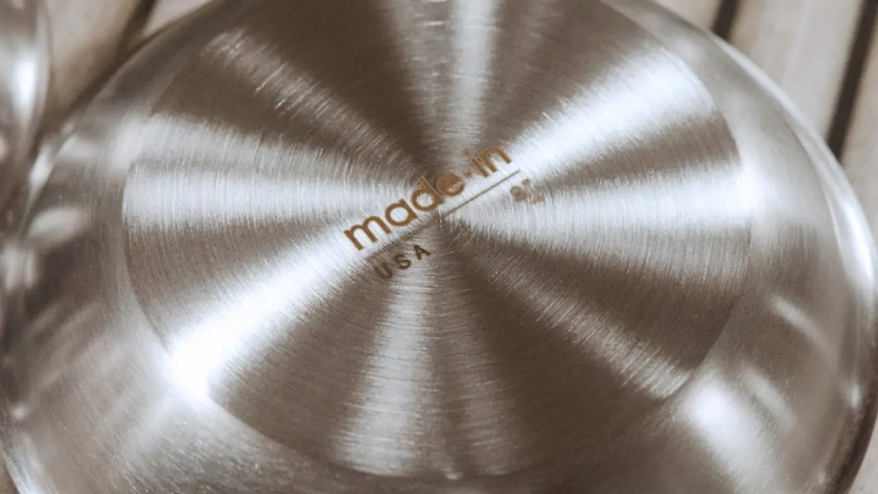 A close-up view of a metallic surface with a radial brushed finish and the words "made in USA" imprinted in the center.