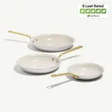 Three frying pans of varying sizes with a gold handle and a light-colored non-stick interior, accompanied by a "5 Leaf Rated" eco-friendly label.