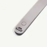 A close-up of a stainless steel tool with the number 3 engraved at one end and a circular indent near it.