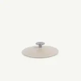 A simple, modern metal lid with a knob handle against a white background.