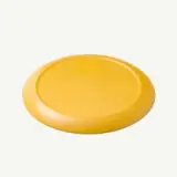 A round, bright yellow frisbee rests on a light background.
