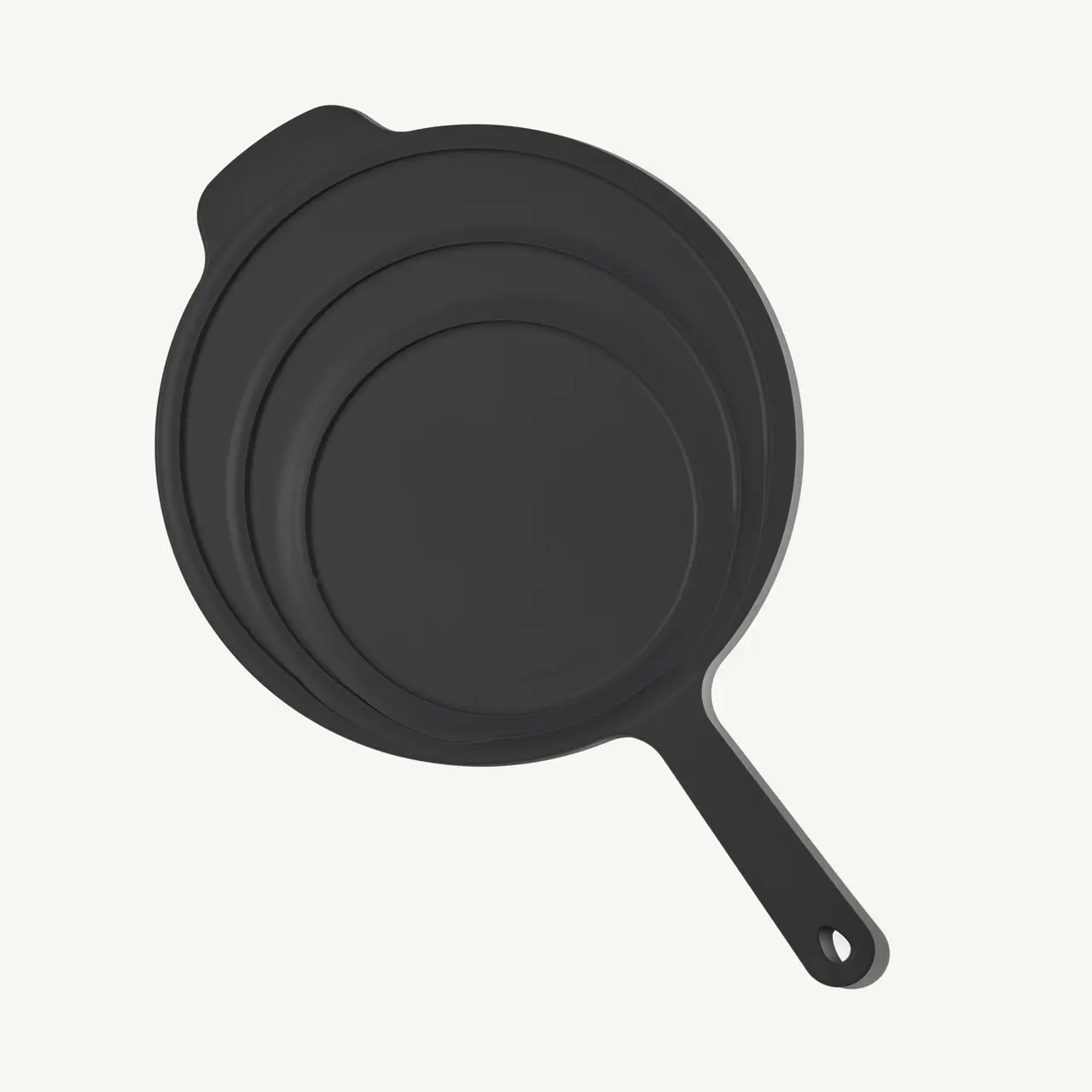 A black, non-stick skillet with a handle, featuring a simple and modern design.