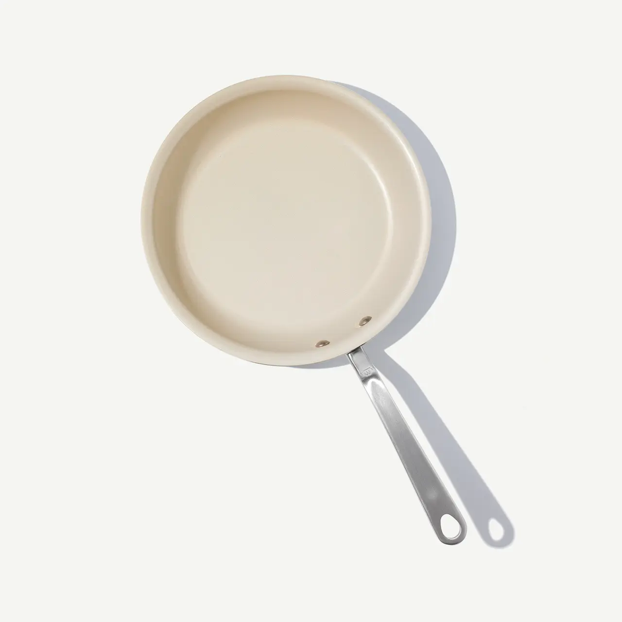 A beige non-stick frying pan with a silver handle is displayed against a light background.