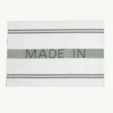 A rectangular white cloth with green stripes featuring the text "MADE IN" prominently displayed in the center.