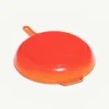 An orange round griddle with a handle is displayed on a plain background.