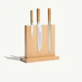 A wooden knife block holds three stainless steel kitchen knives, each with wooden handles, displayed upright.