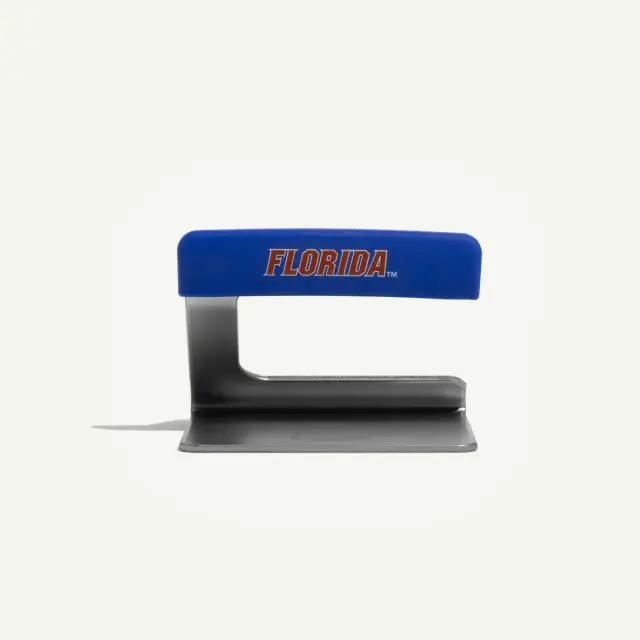 A blue stapler with "FLORIDA" printed on its handle in orange text.
