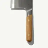 A stainless steel cleaver with a wooden handle and brass rivets.