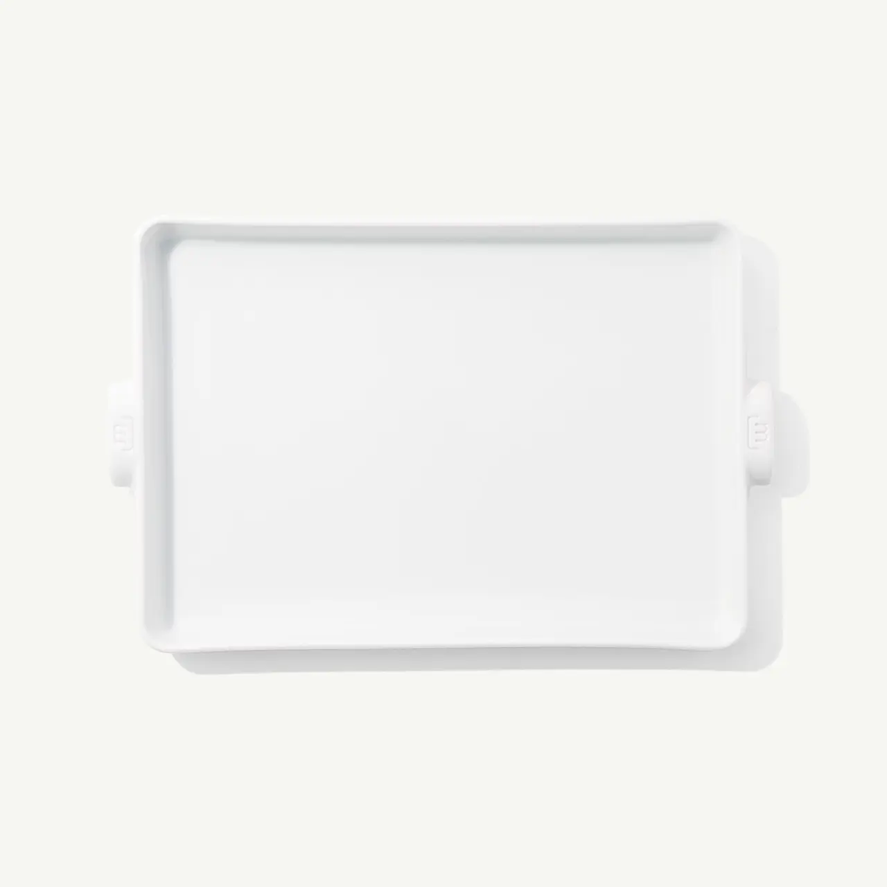 A white rectangular tray with handles viewed from above on a plain background.