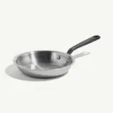 A stainless steel frying pan with a black handle is pictured on a light background.
