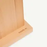 A wooden object with the words "made in" stamped on its surface.