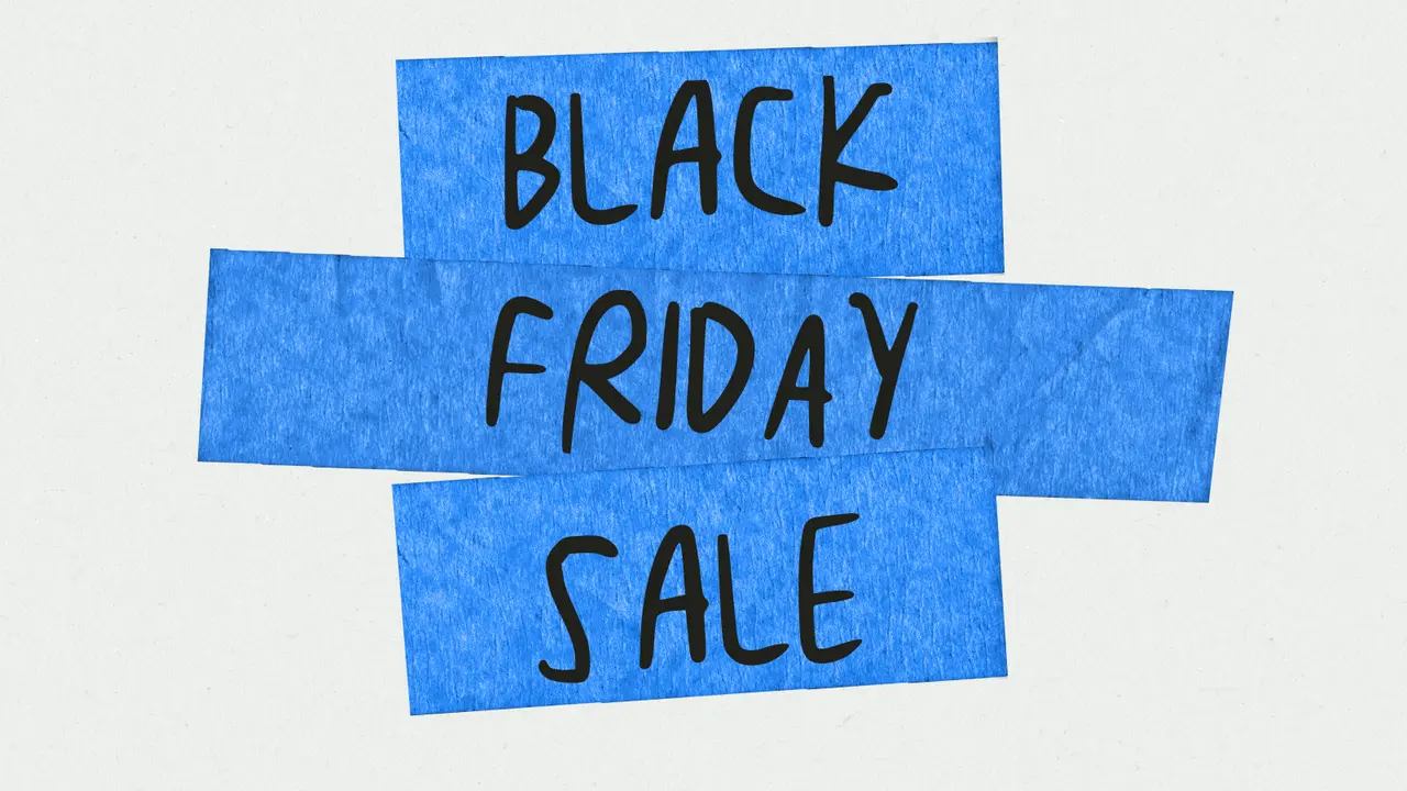 Blue tape crosses over a textured background, with "BLACK FRIDAY SALE" written across them in black marker.