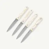 Four stainless steel knives with elegant, glossy cream-colored handles displayed on a neutral background.
