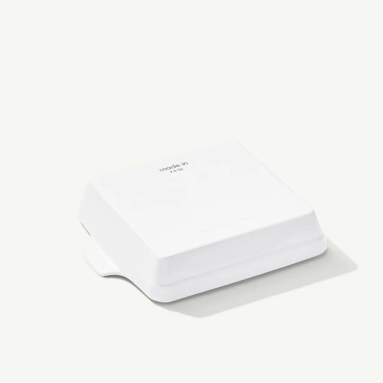 A white, square-shaped device with a minimalistic design sits against a plain background, possibly a smart home gadget or electronic device.