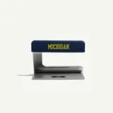 A blue and silver stapler features the word "MICHIGAN" prominently displayed on the top.