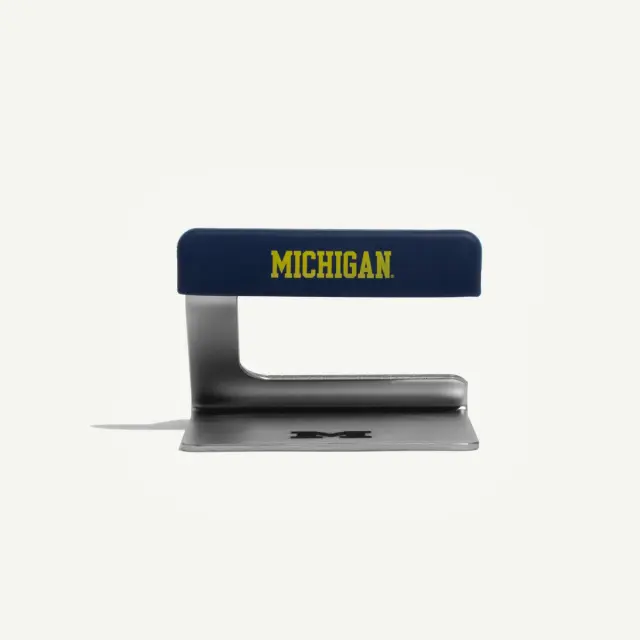 A blue and silver stapler features the word "MICHIGAN" prominently displayed on the top.