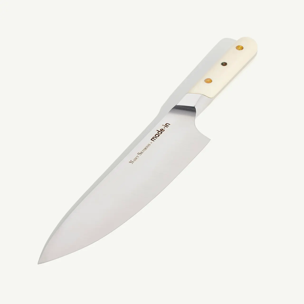 A chef's knife with a white handle and a stainless steel blade against a plain background.