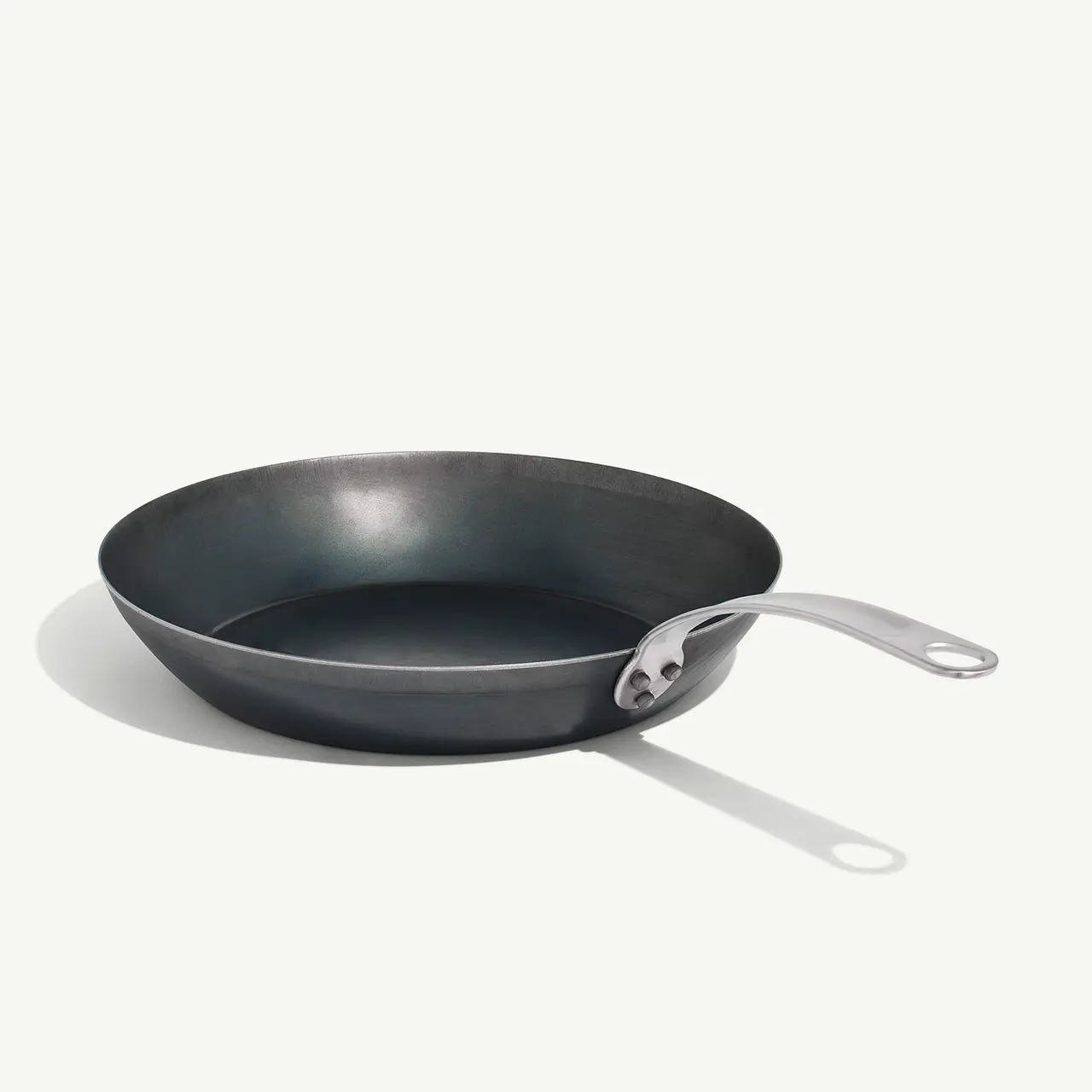 A cast iron skillet with a silver handle is displayed on a plain light background.