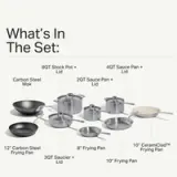 A kitchen cookware set includes various pots, saucepans, and frying pans, each labeled with their respective sizes.