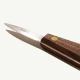 A sleek kitchen knife with a stainless steel blade and a wooden handle featuring a circular brass inlay.