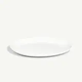 A simple white plate is placed against a light grey background.