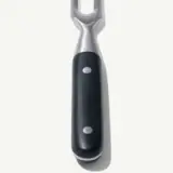 A close-up view of a black and silver bottle opener isolated on a light background.