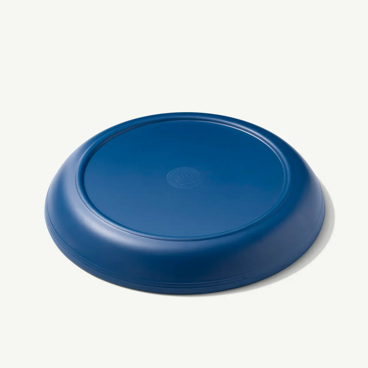 A blue, round frisbee-style disc is shown against a light background.