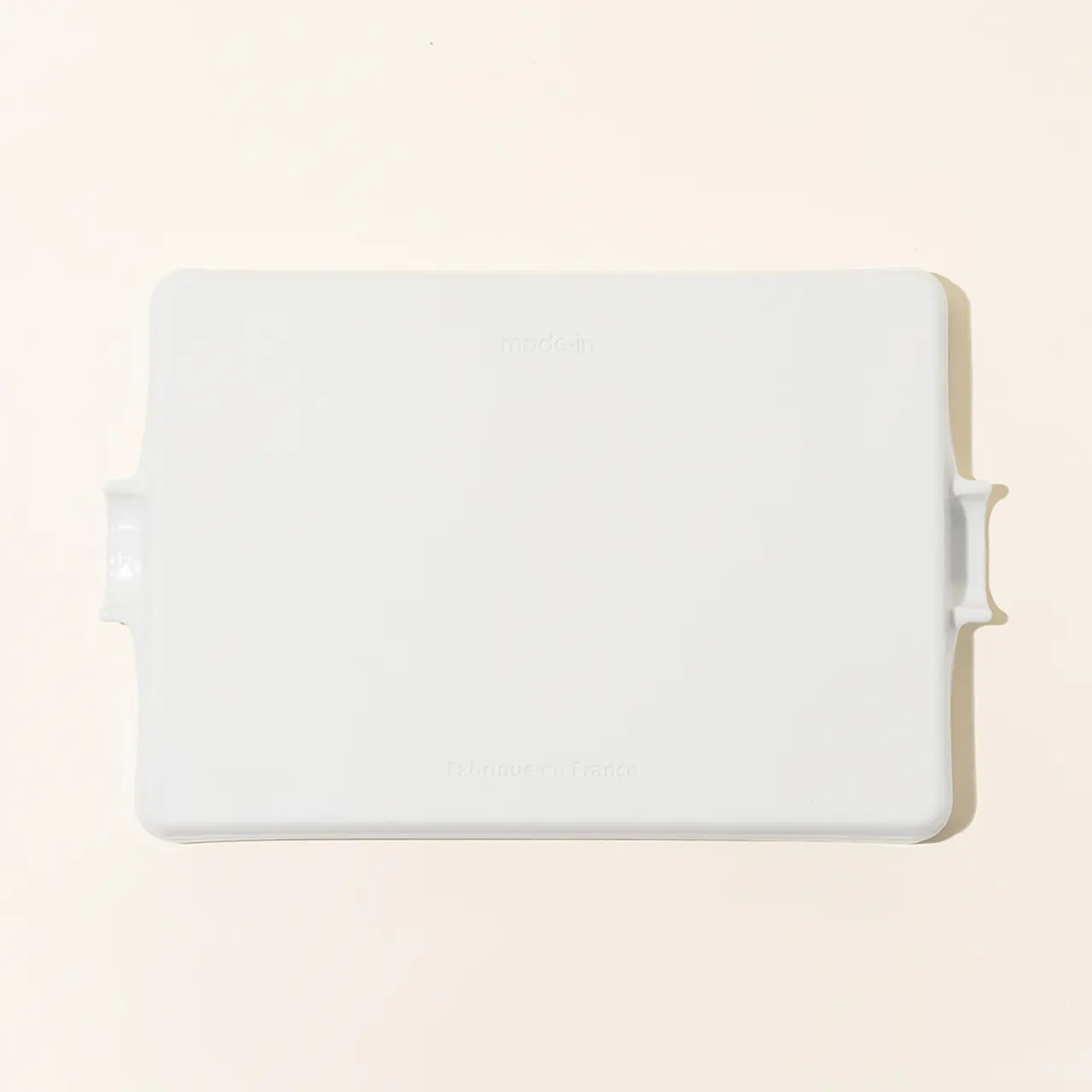 A white, rectangular electronic device with rounded corners and brand text is displayed against a light background.