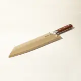 A wooden cricket bat with a brown handle is displayed against a plain background.